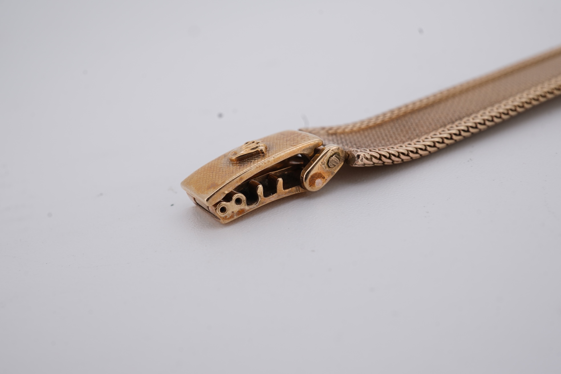 A lady's 1960's 9ct gold Rolex Precision manual wind wrist watch, with square dial, on an integral 9ct gold bracelet, the clasp with Rolex crown, overall length 15cm, gross weight 22 grams (bracelet a.f.)